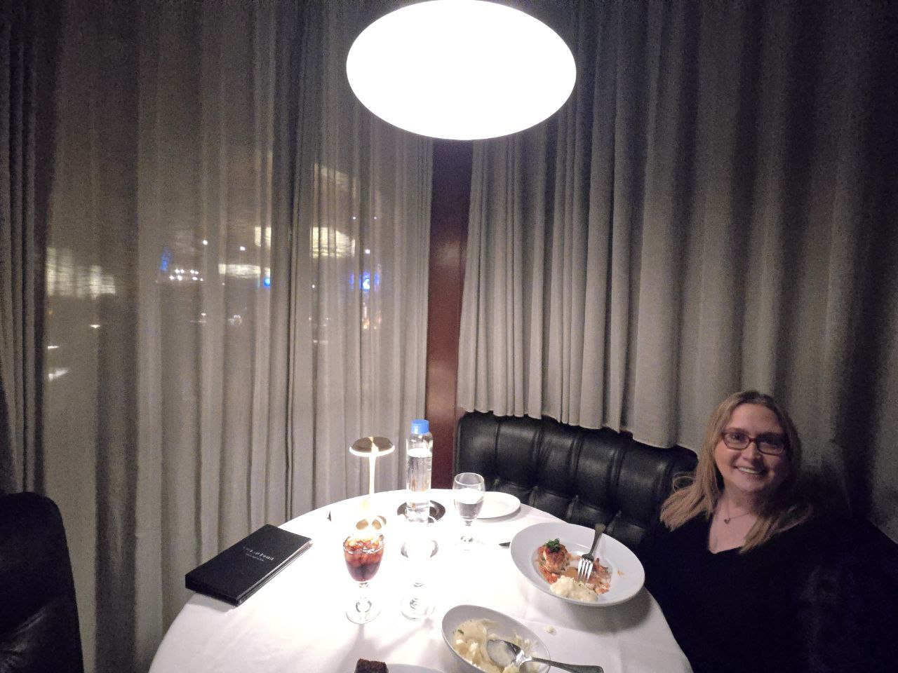 Full spread of anniversary dinner at Ocean Prime Orlando with steak grouper and sides