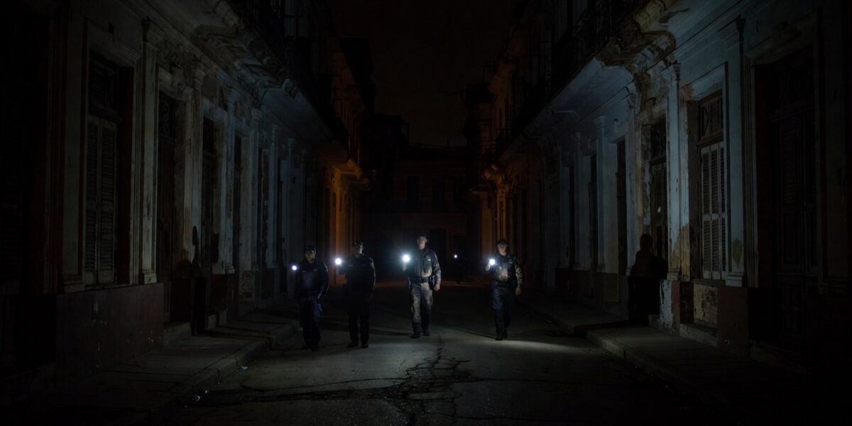 Cuban police patrolling dark Havana streets during blackout protests 2026