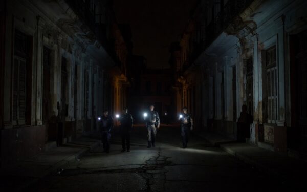 Cuban police patrolling dark Havana streets during blackout protests 2026